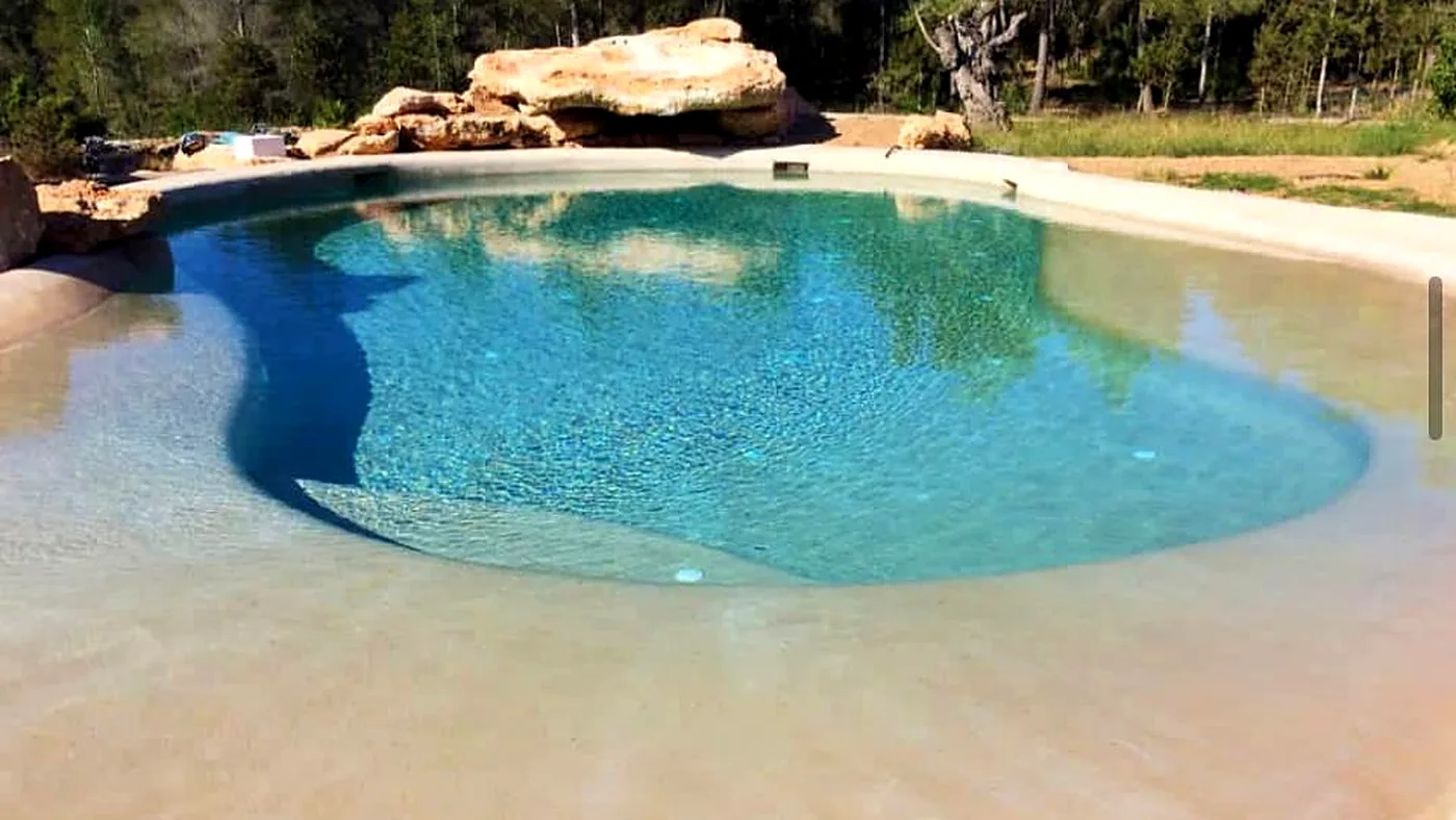 Lagoon pool with a beach entry finished in quartz aggregate