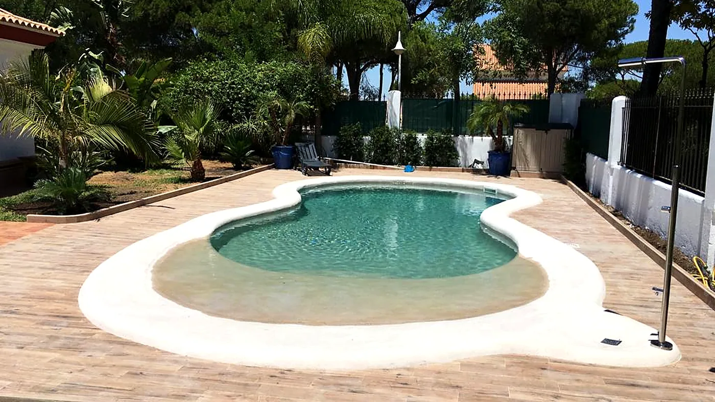 Lagoon pool with a beach entry at a villa